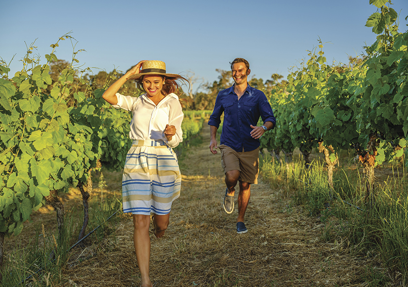 Couple walking through the vines at Wills Domain, Margaret River